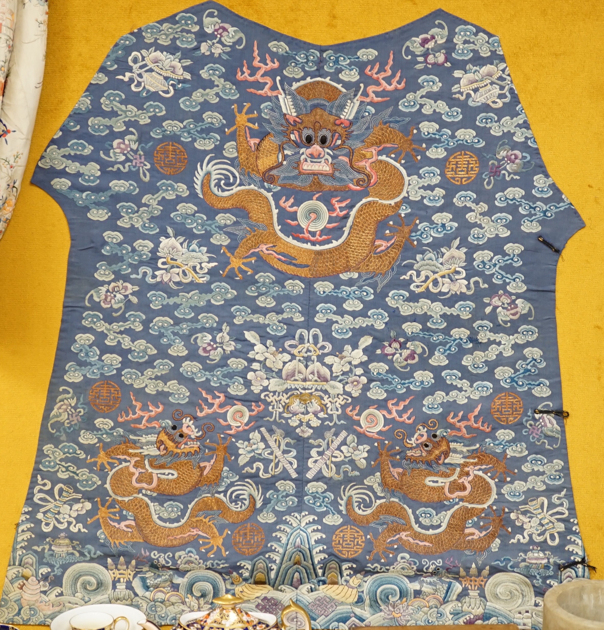 An early 20th century Chinese silk embroidered panel, from a robe, embroidered in metallic and coloured threads as dragons and auspicious symbols